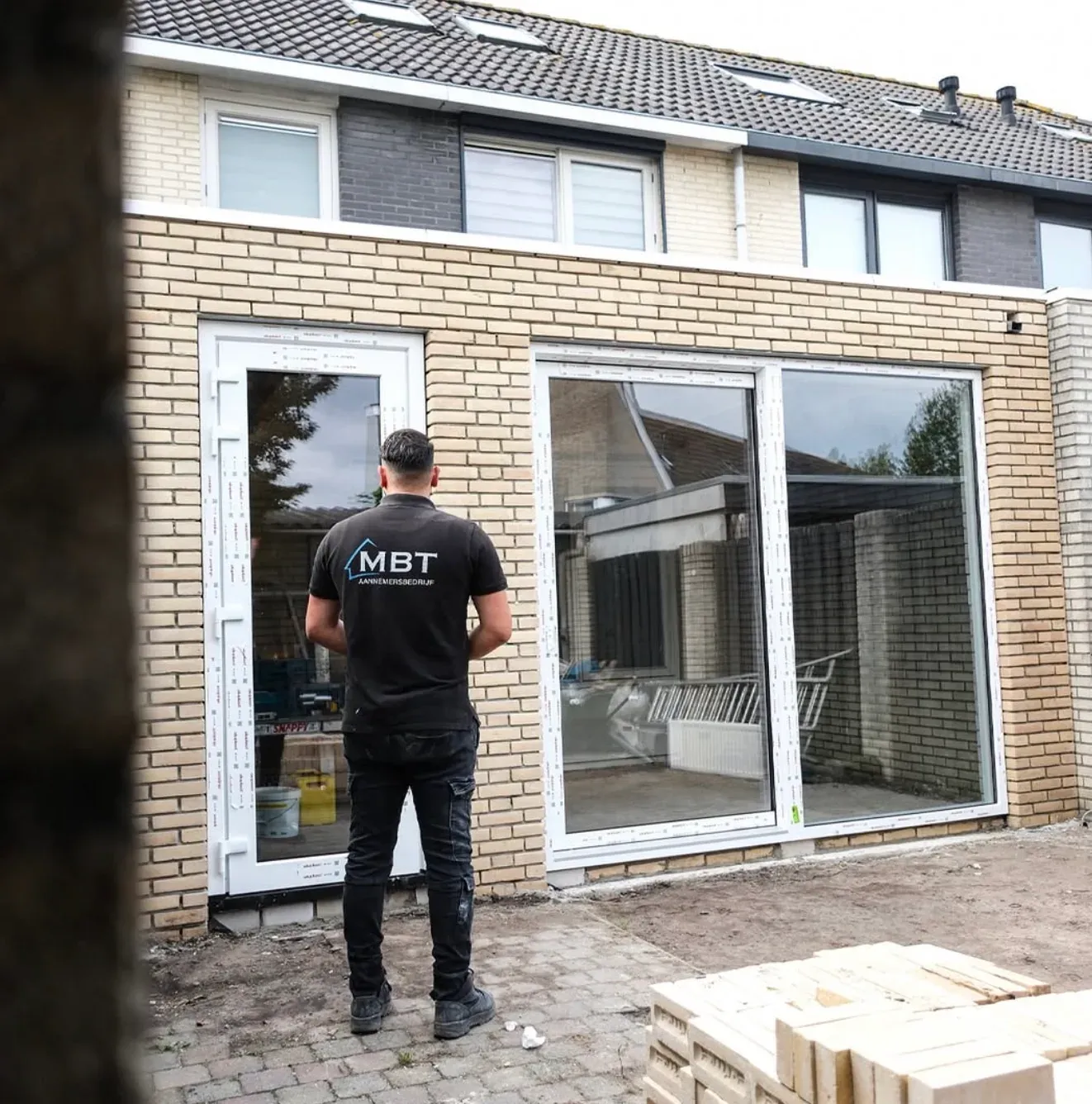 Nieuwe aanbouw met openslaande deuren in de casco fase, voor de afwerking